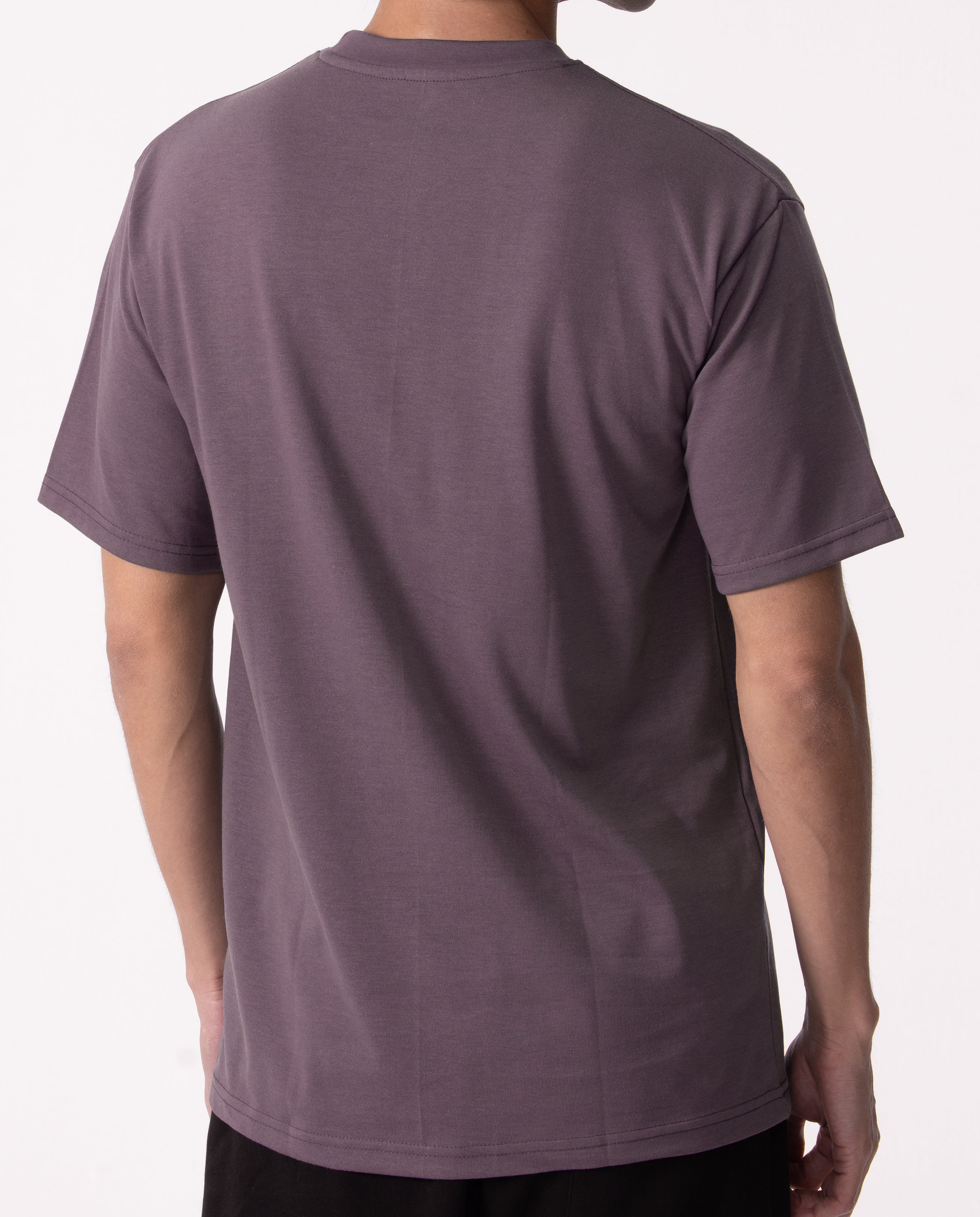 Person wearing a plain purple t-shirt on a white background
