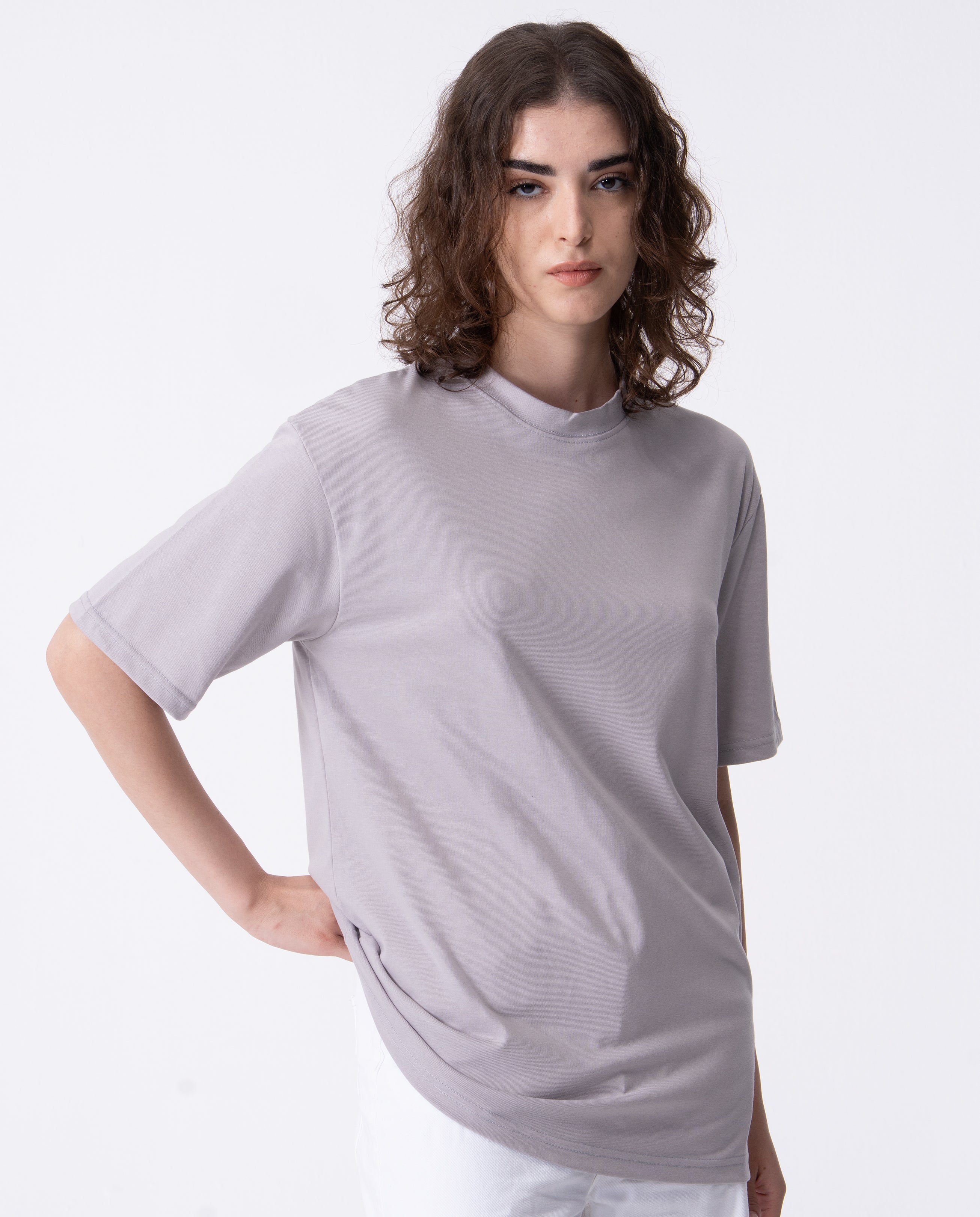 Person wearing a light gray t-shirt on a white background