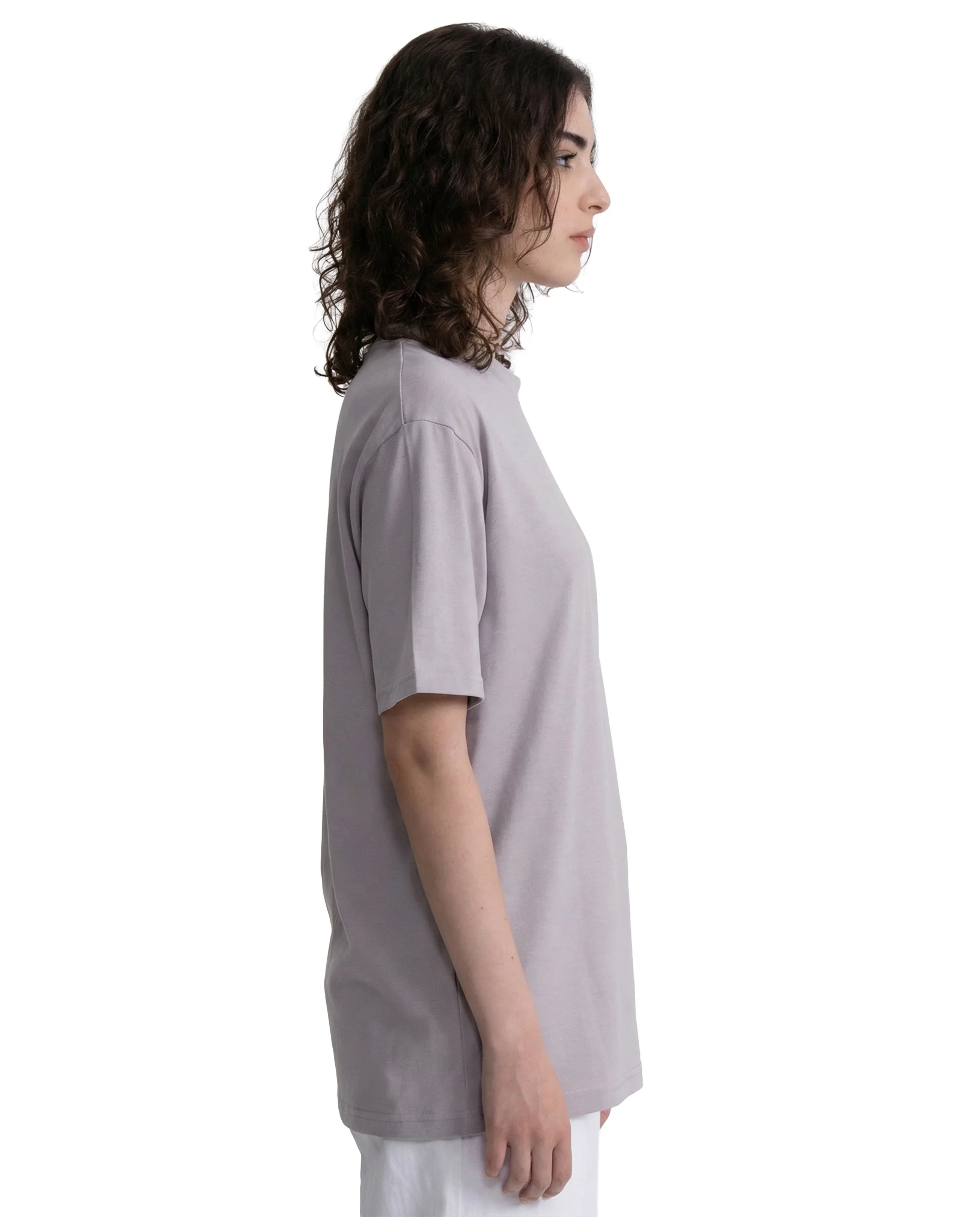 Person wearing a light gray t-shirt on a white background