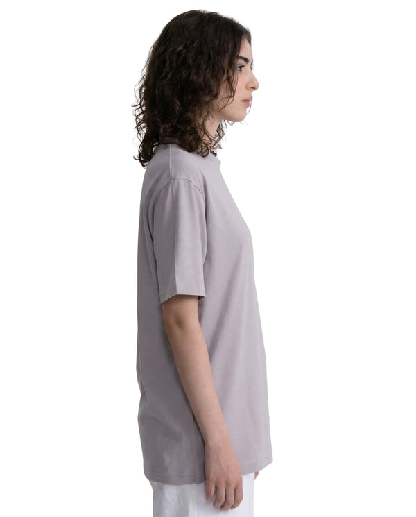Person wearing a light gray t-shirt on a white background