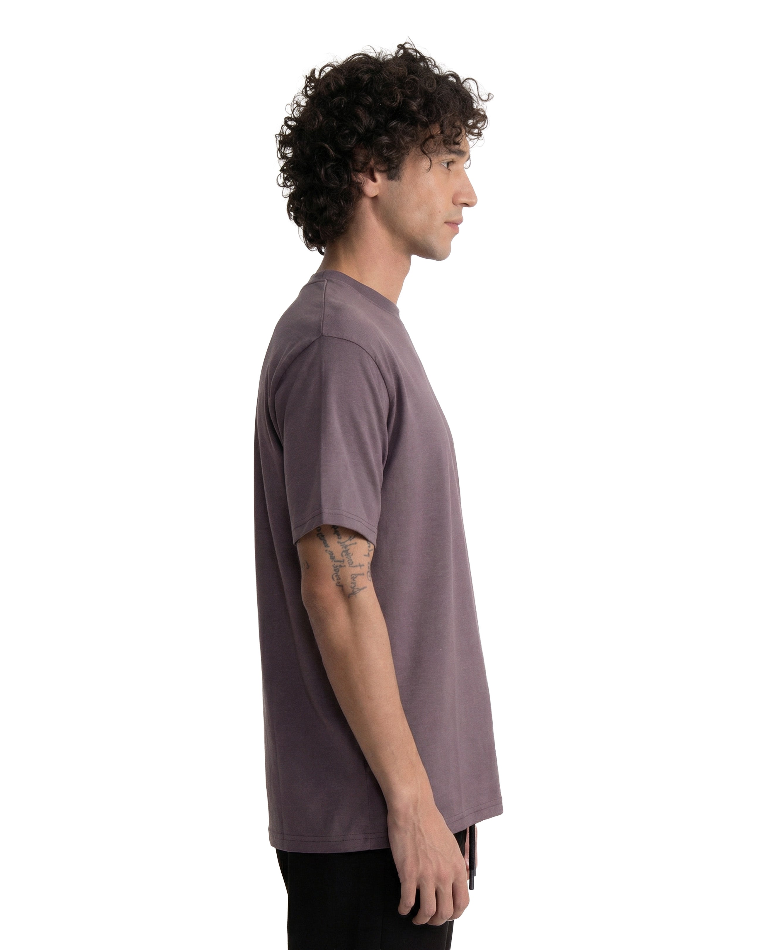 Man wearing a plain brown t-shirt on a white background