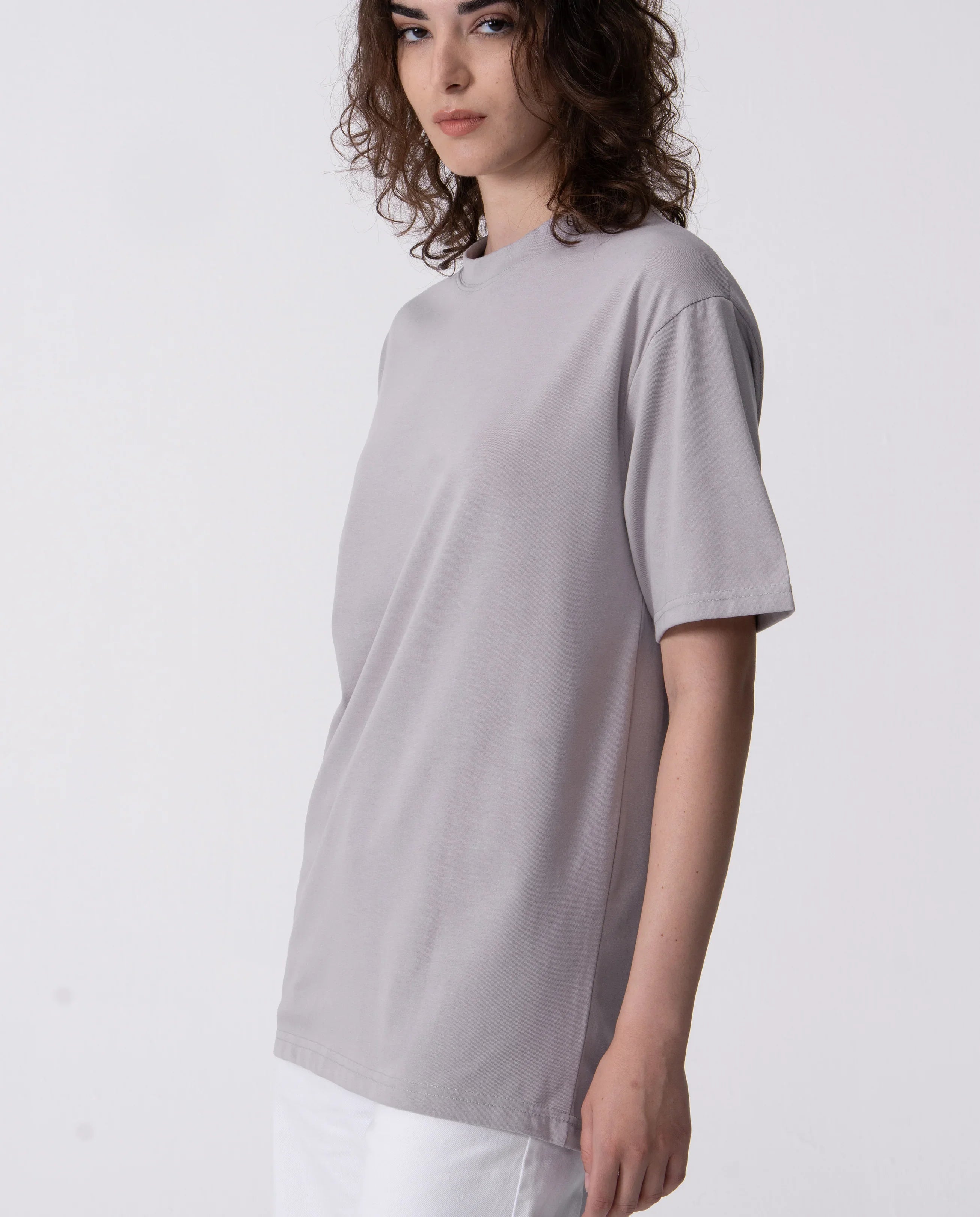 Woman wearing a light gray t-shirt on a white background