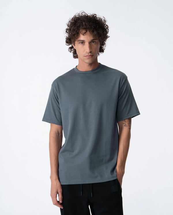 Man wearing a plain gray t-shirt on a white background