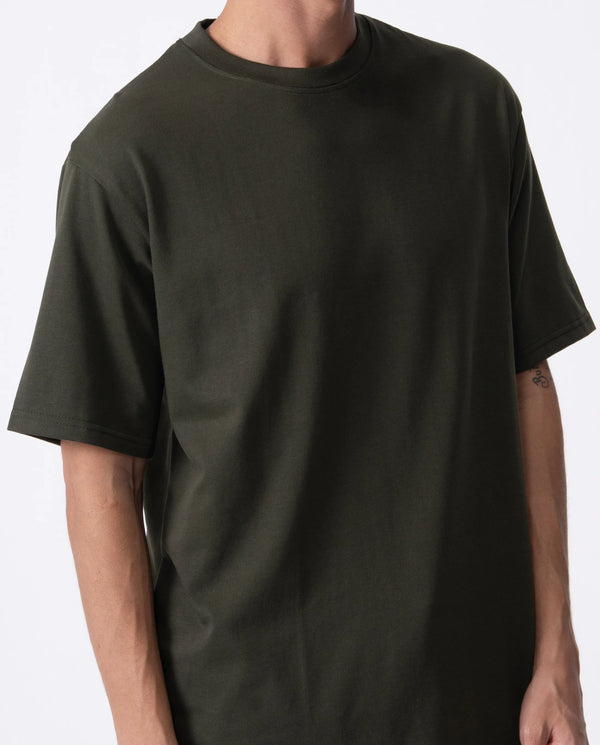 Person wearing a plain black t-shirt on a white background