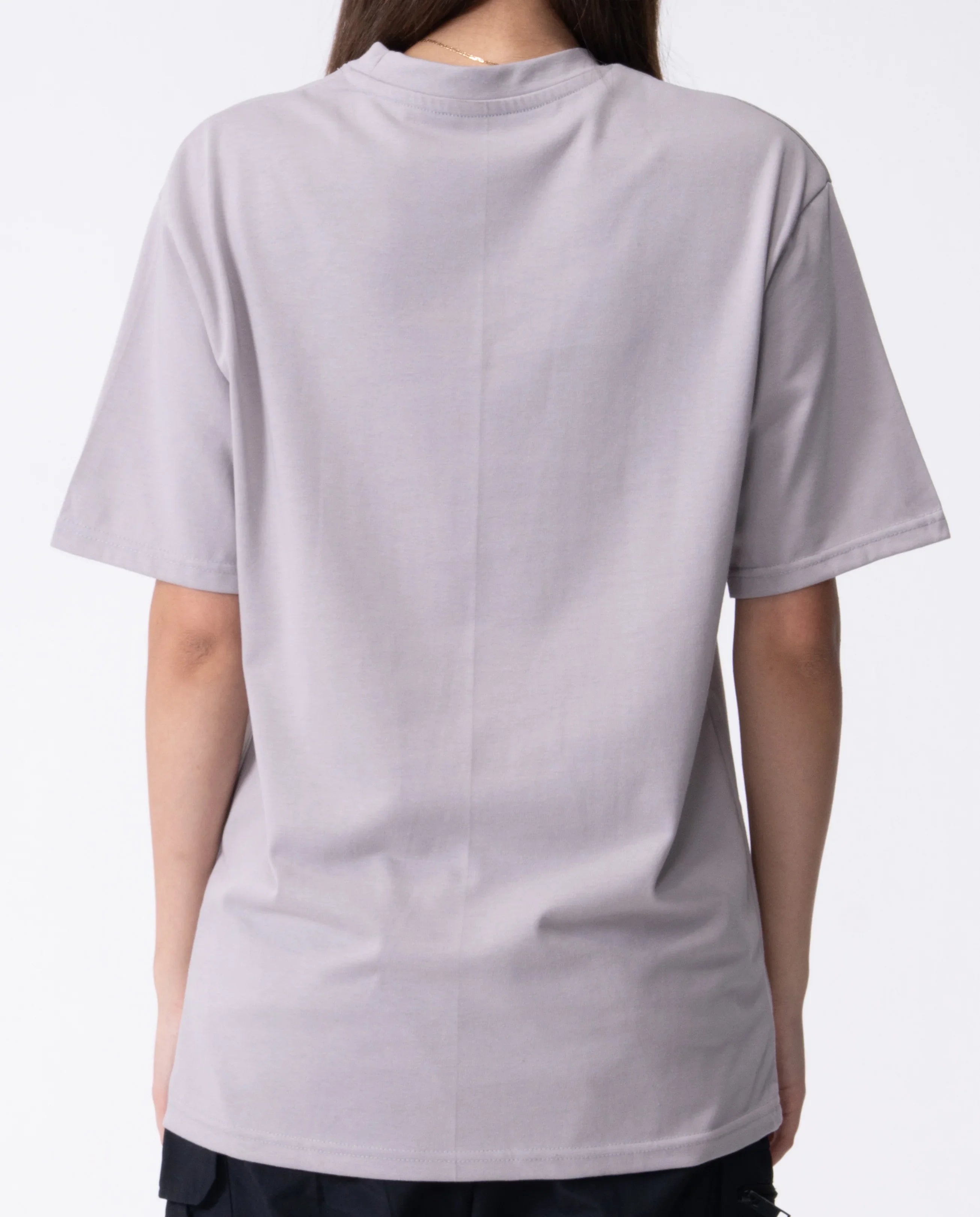 Person wearing a light gray t-shirt on a white background