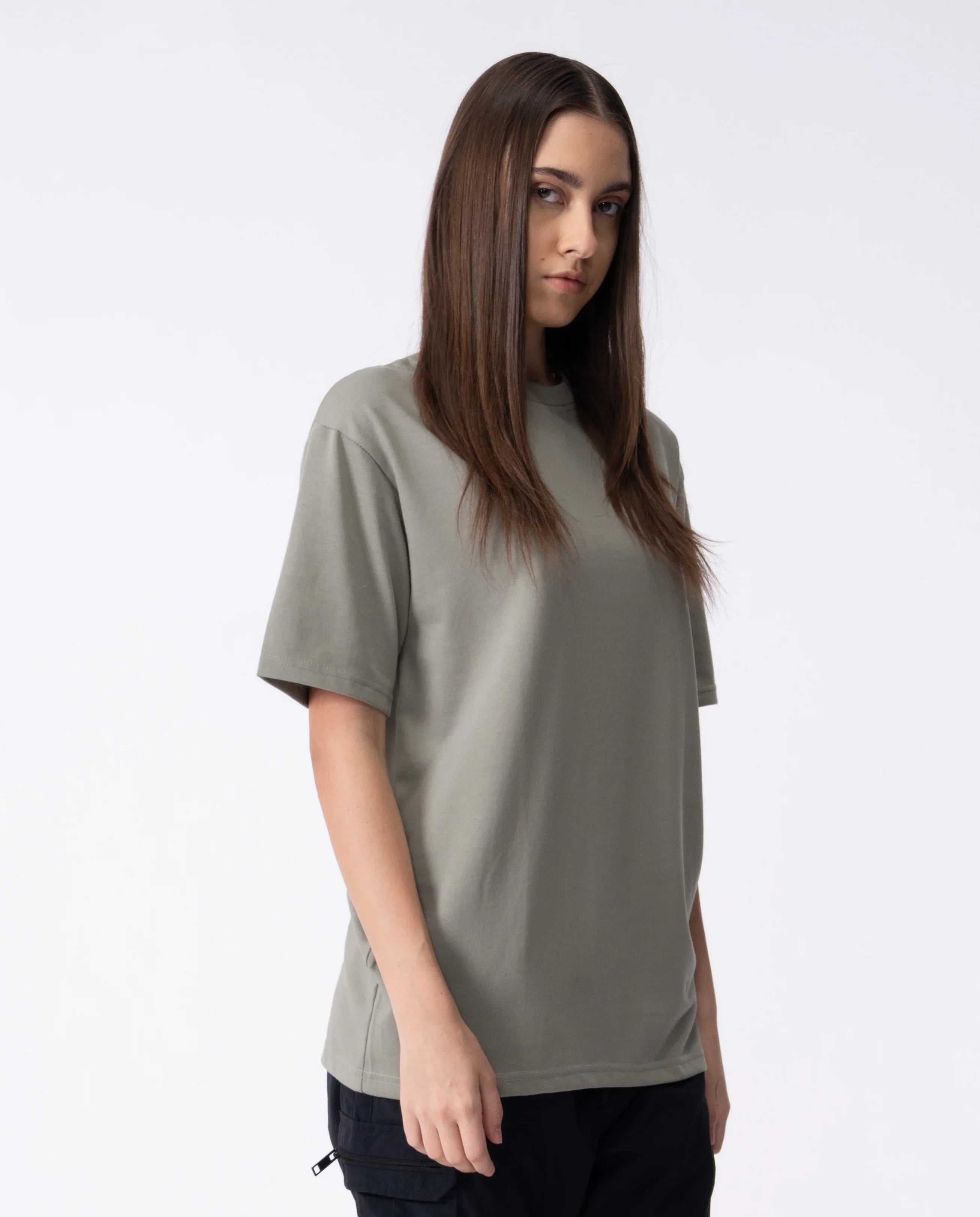 Woman wearing a plain gray t-shirt against a white background