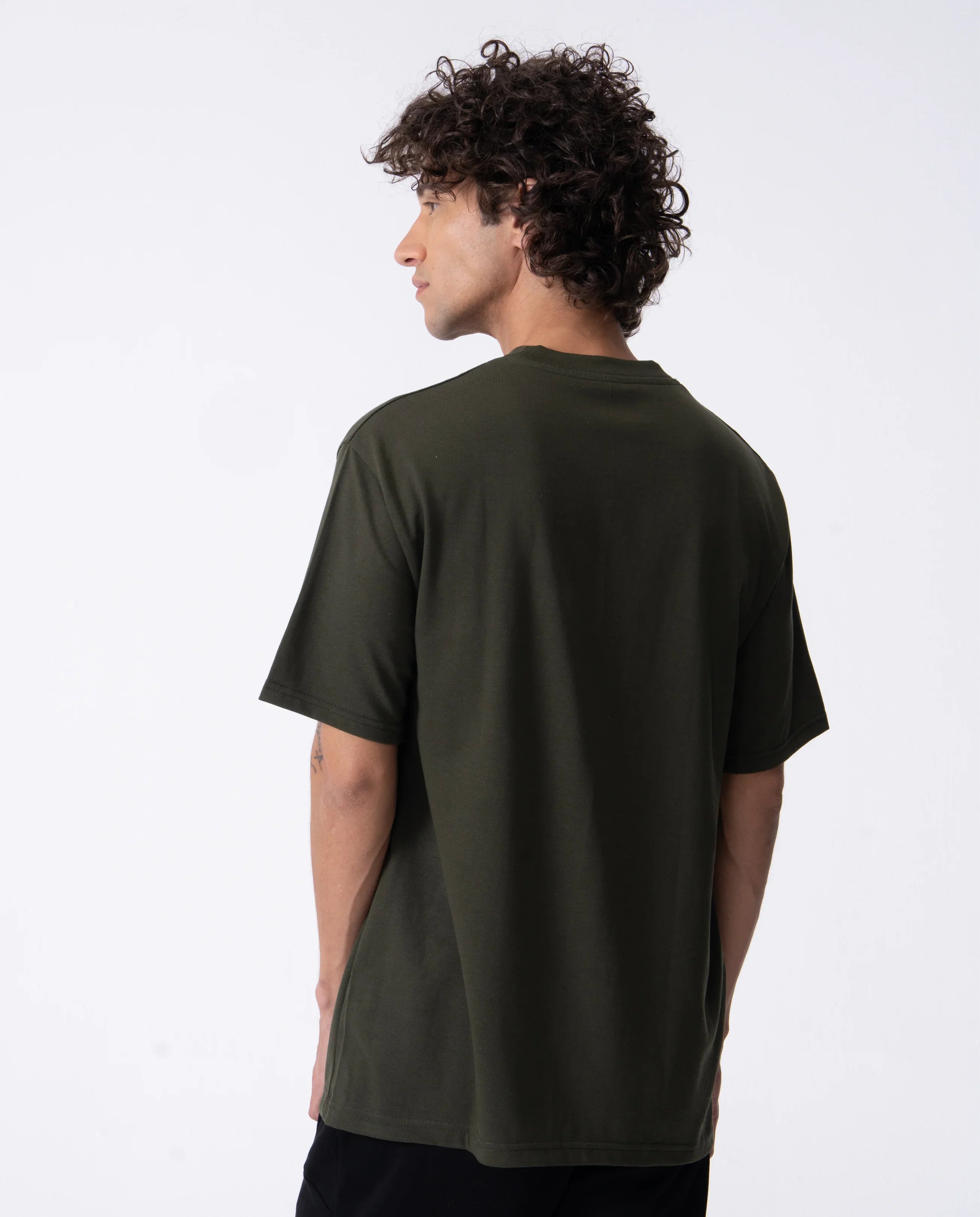 Person wearing a dark green t-shirt on a white background