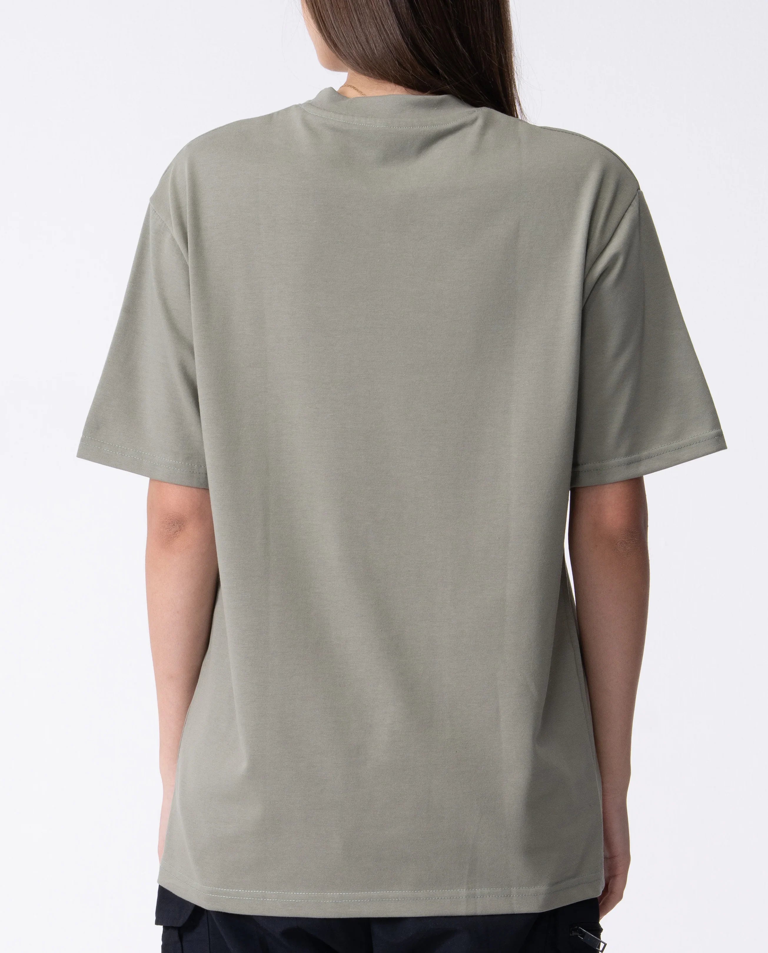 Person wearing a plain gray t-shirt on a white background