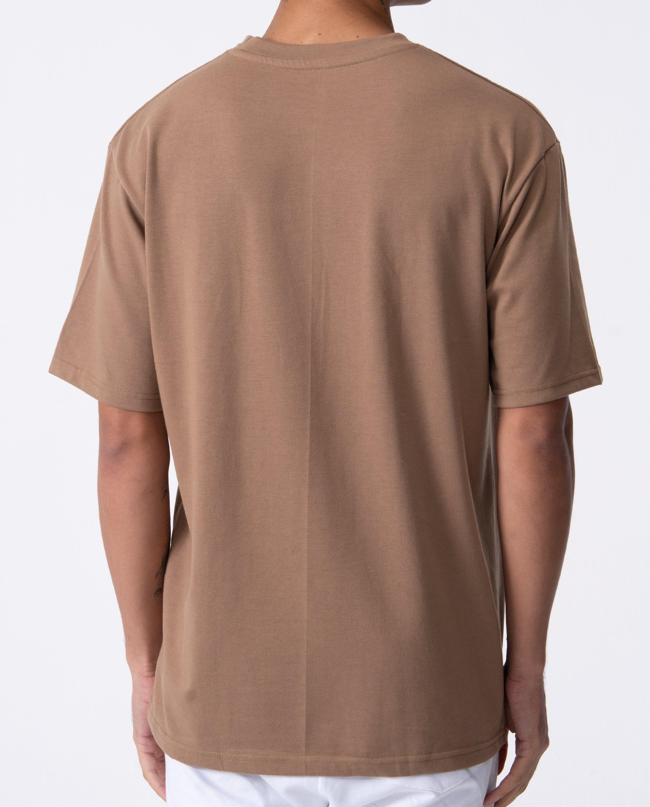 Brown t-shirt worn by a person on a white background