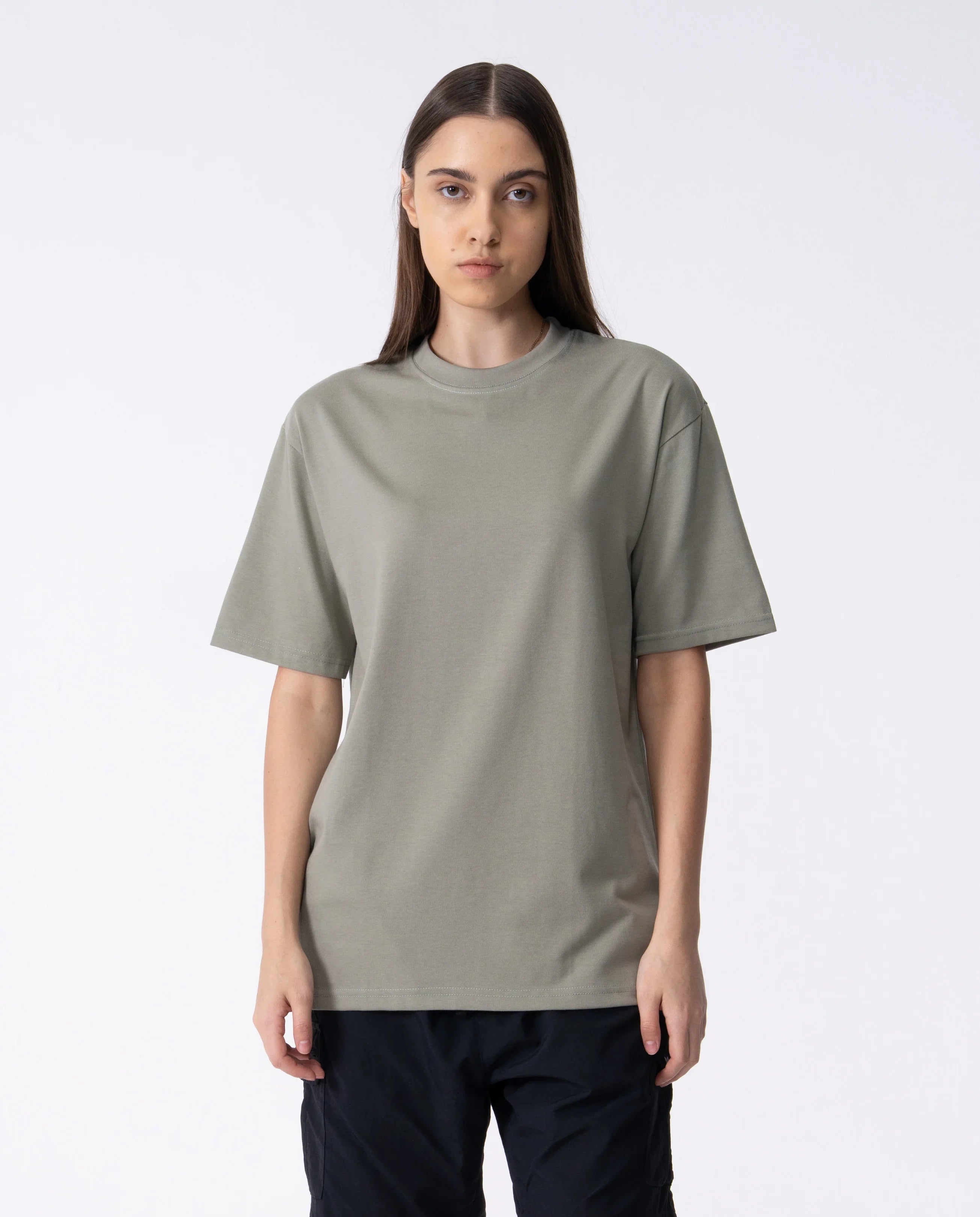 Person wearing a plain gray t-shirt on a white background