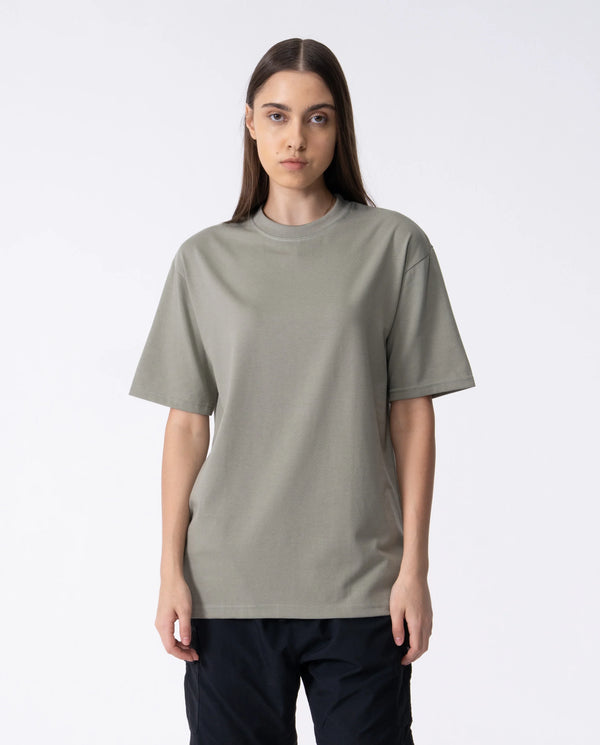 Person wearing a plain gray t-shirt on a white background