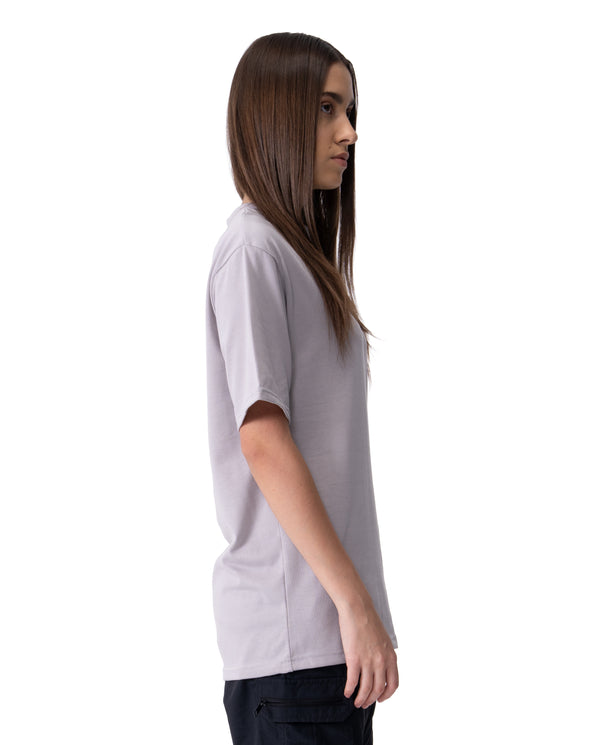 Person wearing a light gray t-shirt on a white background