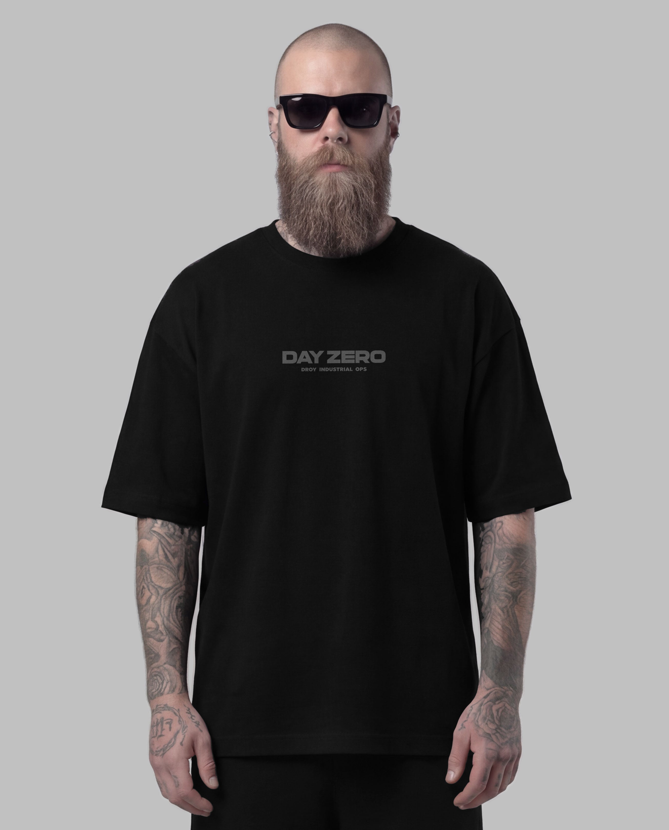 Man wearing a black 'Day Zero' t-shirt against a gray background