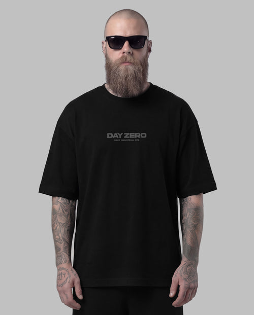 Man wearing a black 'Day Zero' t-shirt against a gray background