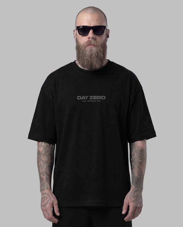 Man wearing a black 'Day Zero' t-shirt against a gray background