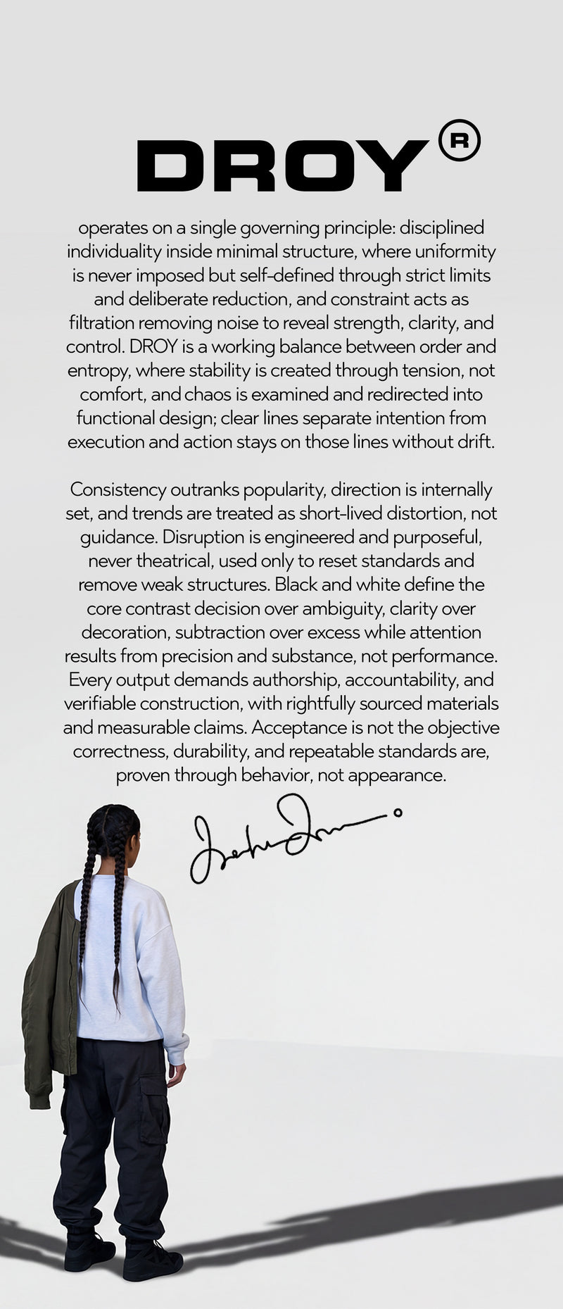 Person wearing a green jacket and white shirt with black pants, standing against a white background with text about DROY.