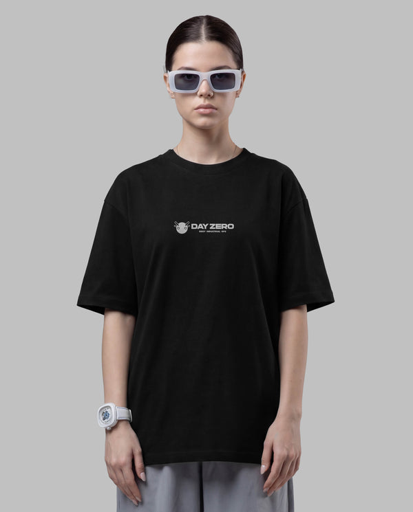 Person wearing a black t-shirt with a logo on a gray background